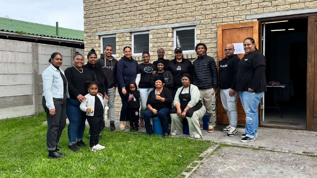 The YouthTable S.A. team standing together outside the church